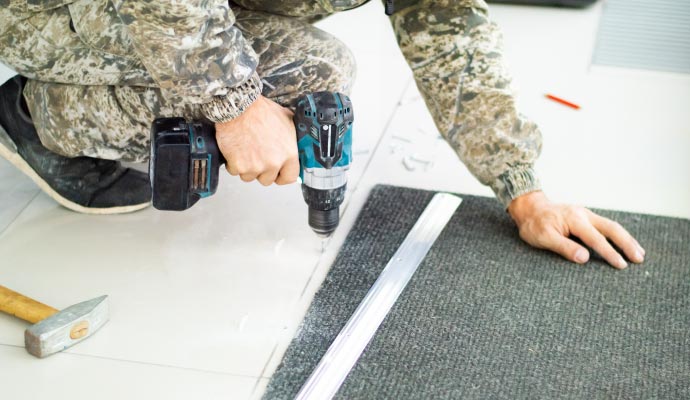 Professional worker repairing carpet seam