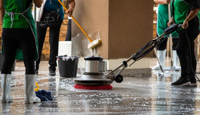 Professional worker cleaning concrete floor
