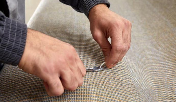 Professional worker repairing carpet