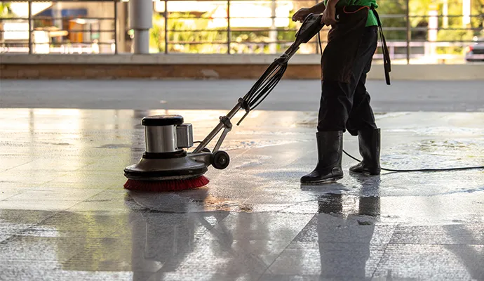 professional worker cleaning concrete floor