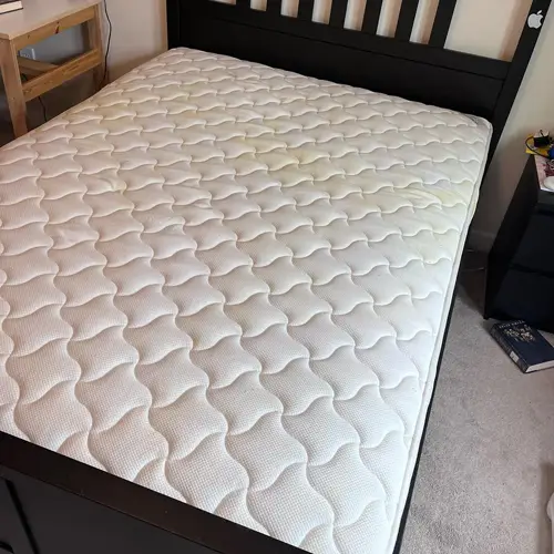 A clean mattress on a bed