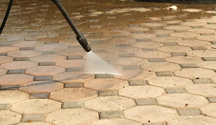 professional worker pressure washing a floor