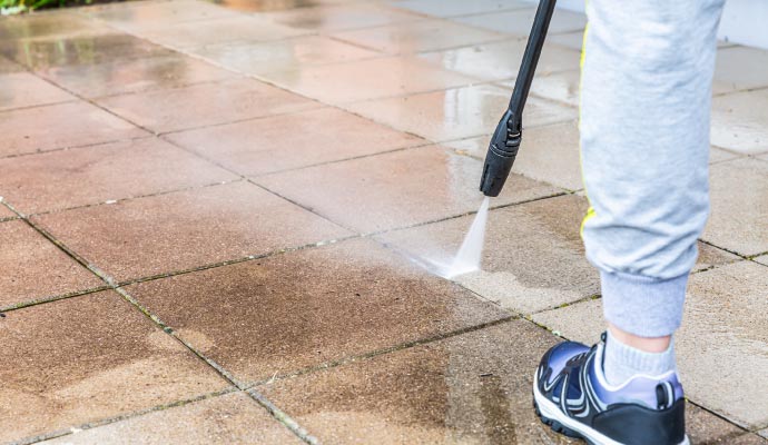 Professional worker cleaning patios