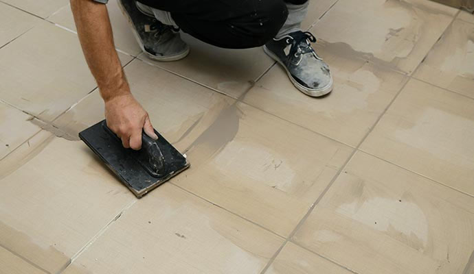 Professional worker sealing grout